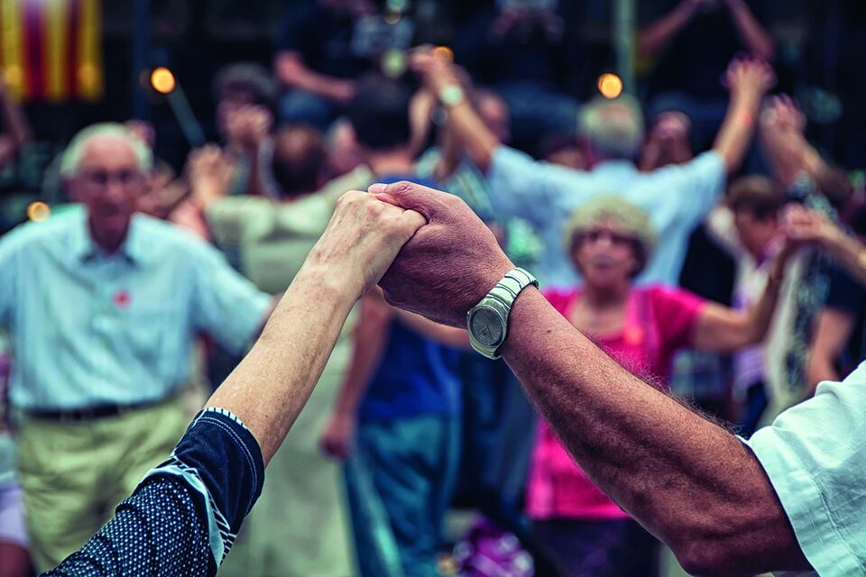 Blick auf ältere Menschen, die beim Tanzen ihre Hände halten