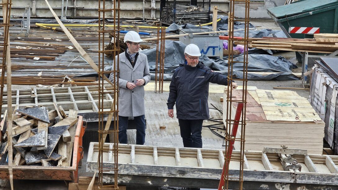 Stadtrat Nils Kraft (links) und Fachbereichsleiter Gebäudewirtschaft Jochen Brandner begutachten die begonnen Rohbauarbeiten an der Parkschule (Foto: Stadt Rüsselsheim am Main)
